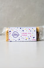 Load image into Gallery viewer, Creme Egg white chocolate fudge in purple branded packaging 
